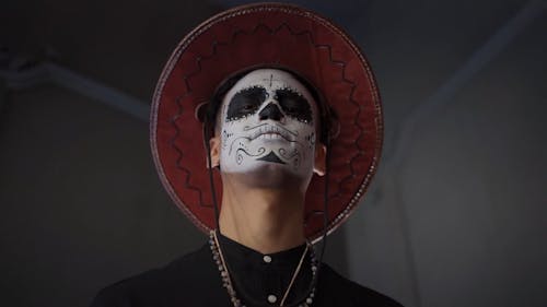 A Man with a Muertos Face Painting