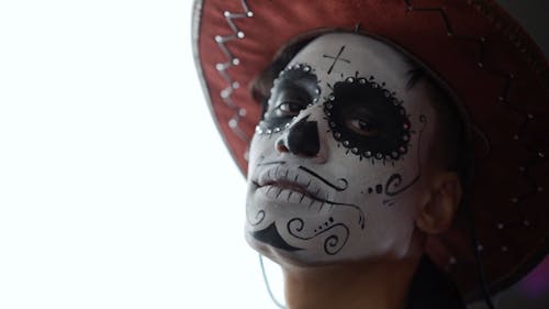 A Man with a Muertos Face Painting