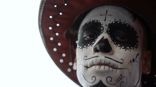 A Man with a Muertos Face Painting