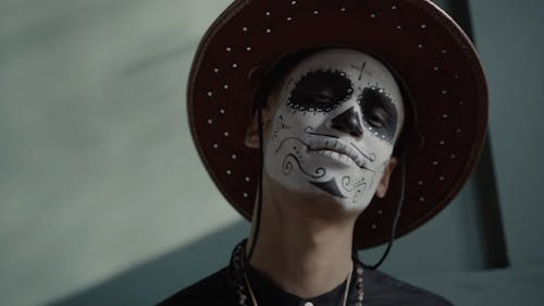 A Man with a Muertos Face Painting