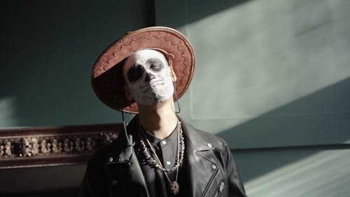 A Man with a Muertos Face Painting