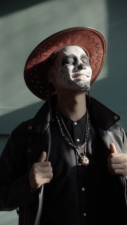 A Man with a Muertos Face Painting