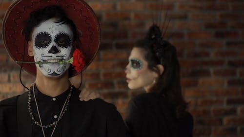 A Couple with a Muertos Face Painting