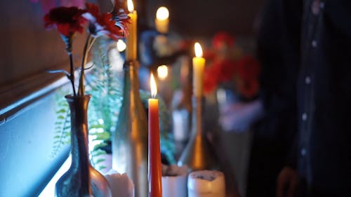 A Couple with a Muertos Face Painting Blowing a Candle