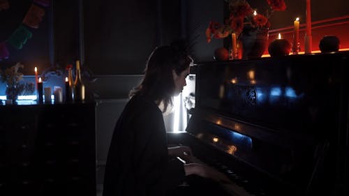 A Woman with a Creepy Makeup Playing a Piano