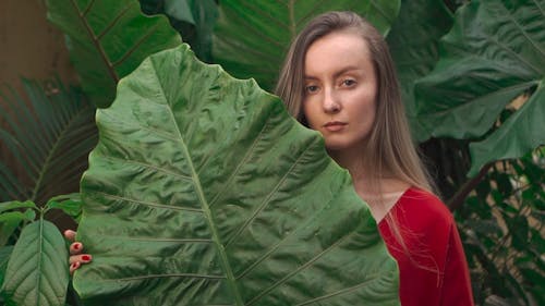 Woman Posing With Giant Green Leaf