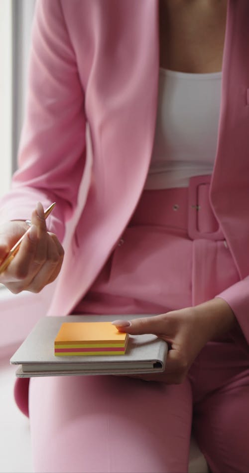 Woman Writing in Sticky Note