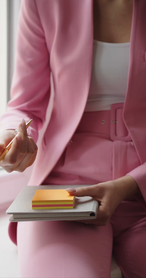 Woman Writing in Sticky Note