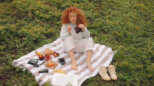 Woman Eating Grapes at the Park 