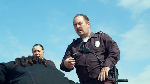 Police Officer Arresting Two People