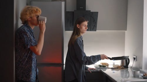 A Couple Making Breakfast in a Kitchen