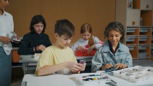 People Assembling Robots