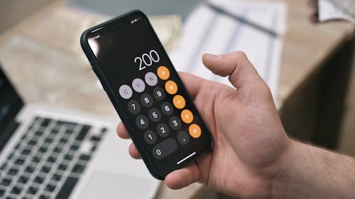 A Person Using the Calculator on a Smartphone