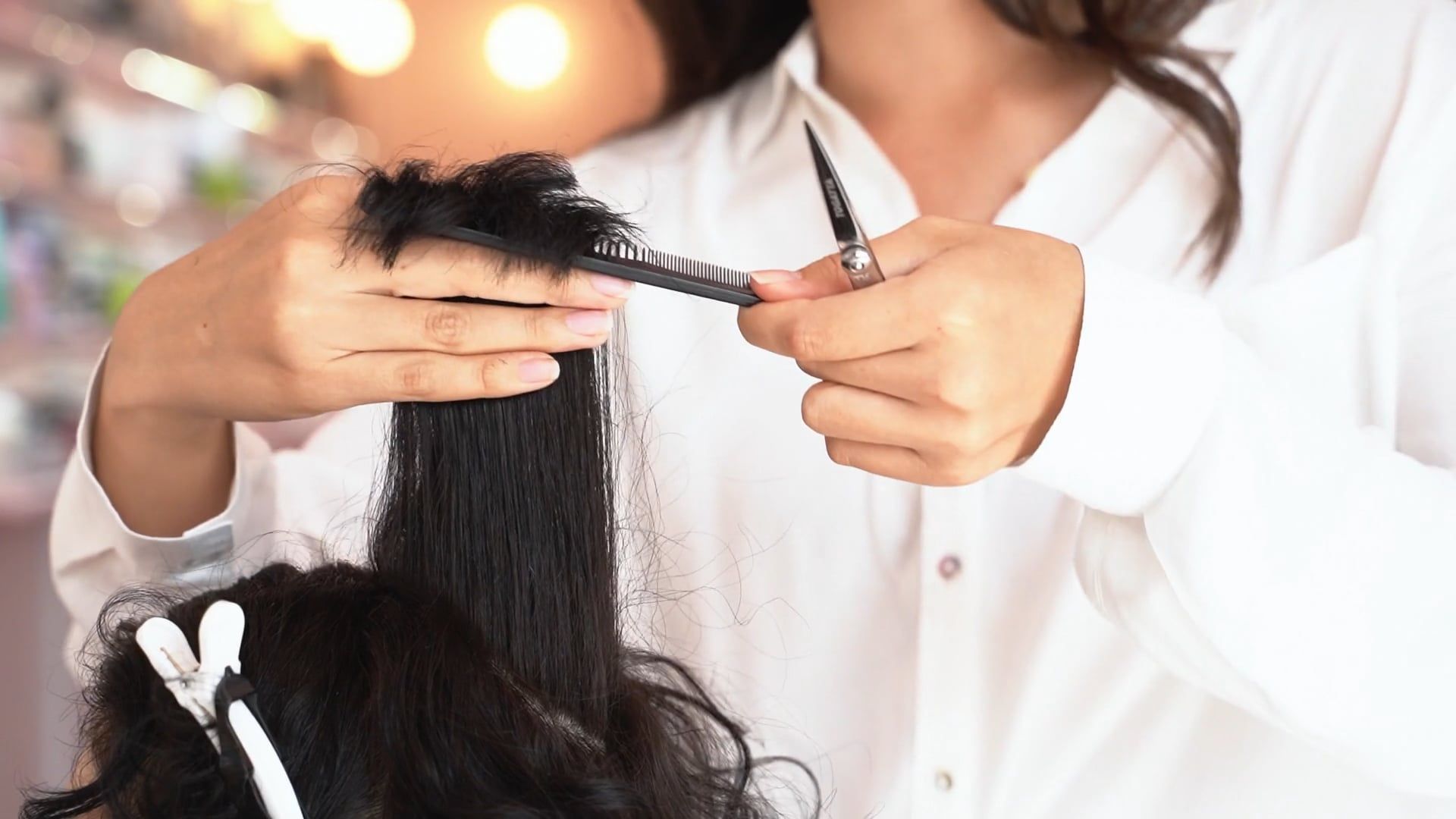 Professional hair stylist cutting hair at VIP Unisex Hair Salon