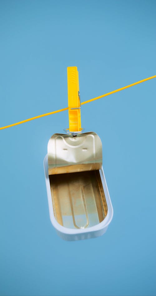 An Open Tin Can Hanging from a Clothesline