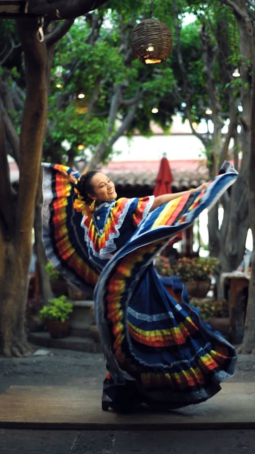A Woman Dancing In Colorful Traditional Dress