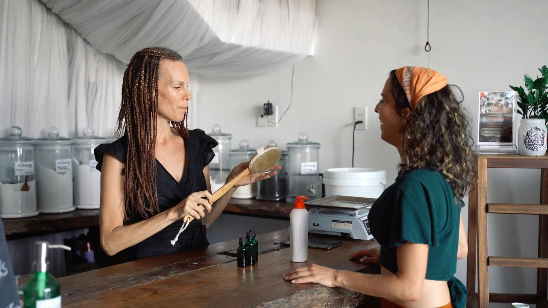 A Woman Demonstrating How to Use Body Scrub Brush · Free Stock Video