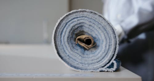 Close up of a Roll of Fabric being Rolled Out