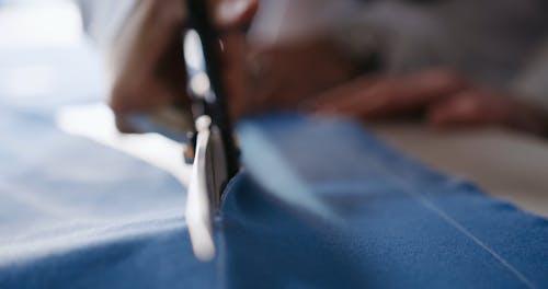 Person Cutting a Fabric