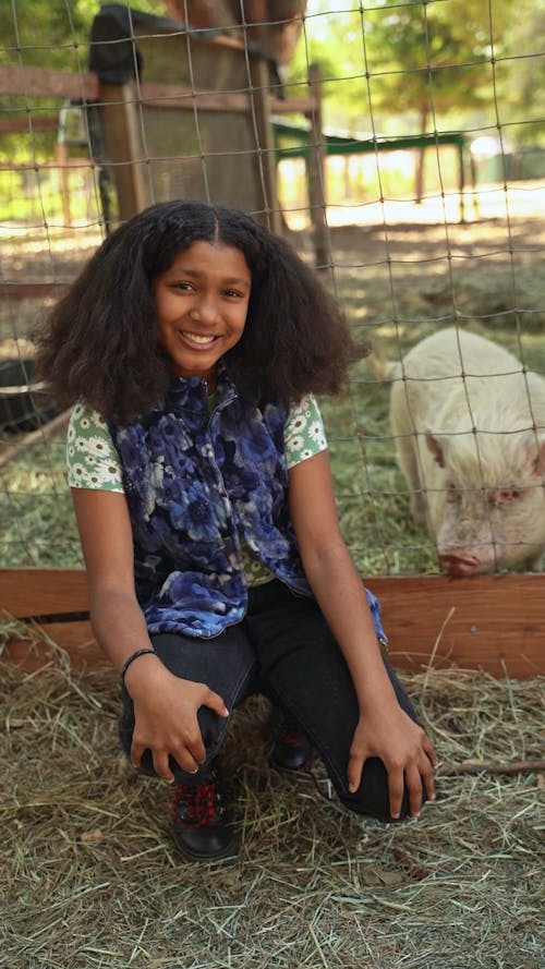 Girl Posing Beside a Pig