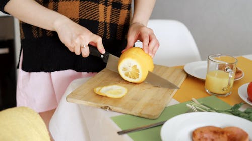 Person Slicing an Orange