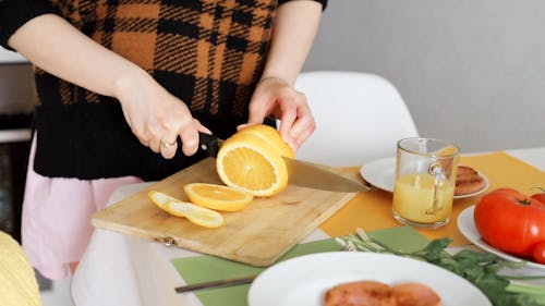 Pregnant Woman Slicing an Orange