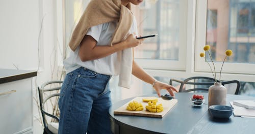 Woman  Taking Pictures of Fruits