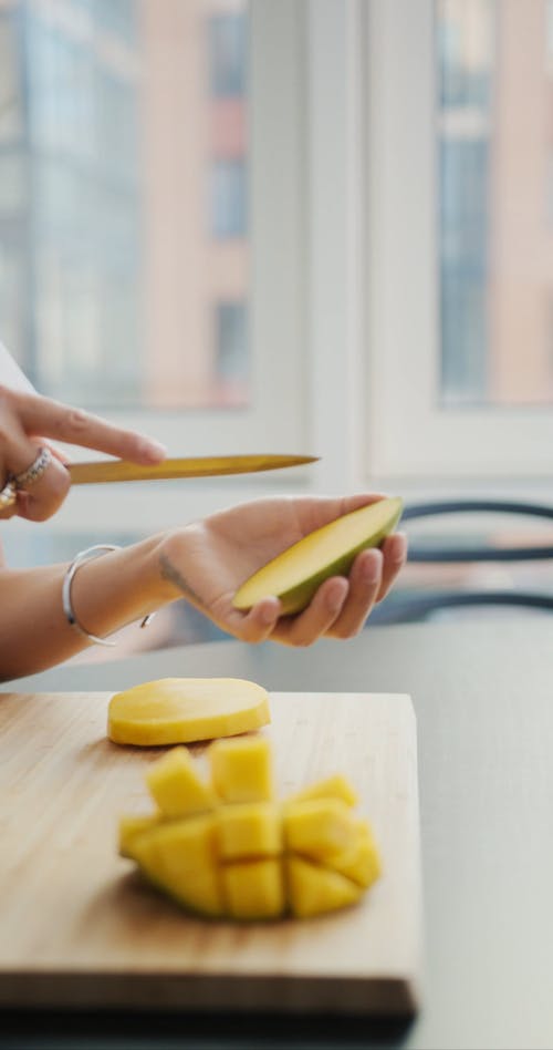 Person Slicing a Mango