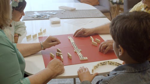 Children and Grandparents Playing Domino