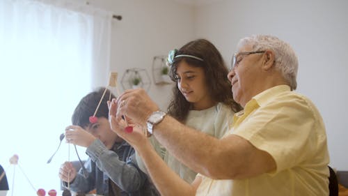 Elderly Man Playing with Grandchildren