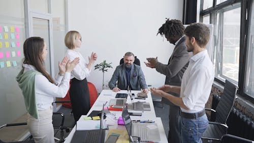 Business Team Clapping During Meeting