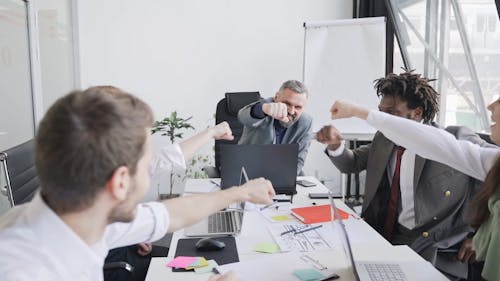 Office Team Huddling Up in the Conference Room