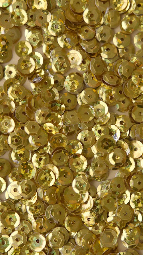 Close Up Shot of Round Gold Confetti