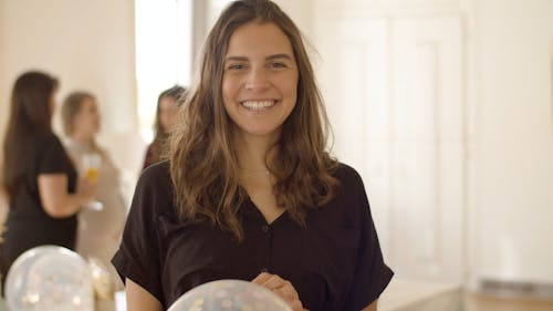 A Woman Posing in the Camera while in the Party