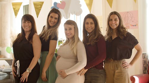 Women Smiling to the Camera while Posing