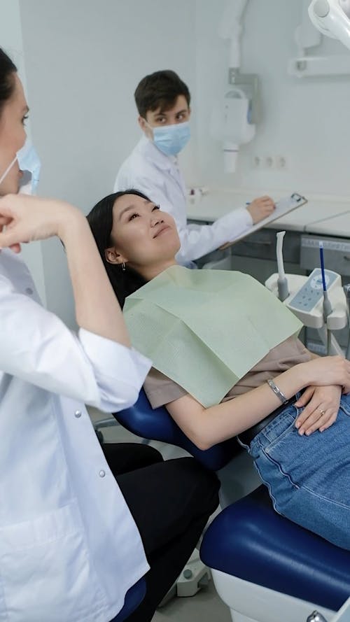 A Dentist Wearing Face Mask and Gloves