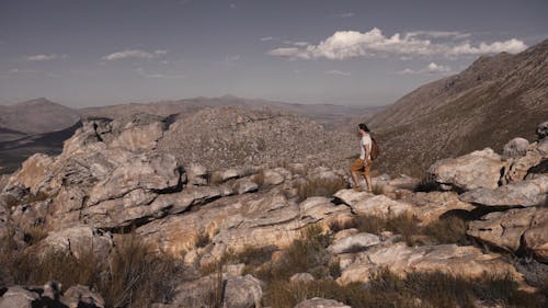 A Man Walking on a Rocky Trail