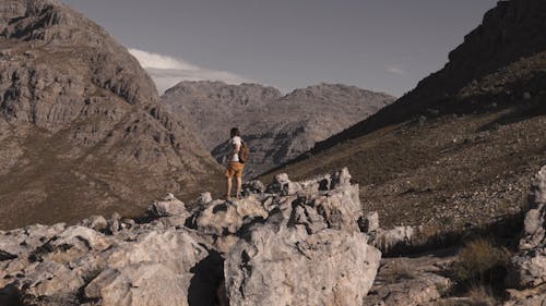 A Man Hiking in a Rocky Mountain