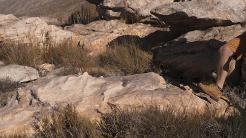 A Man Walking on Rock Formations 
