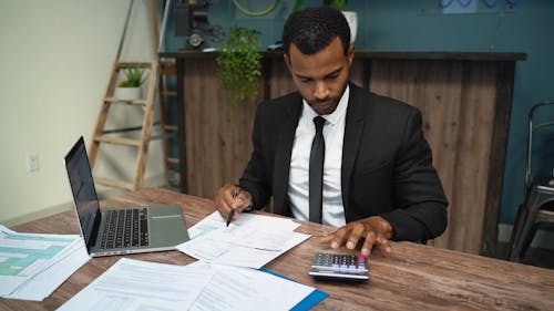 A Man Using a Calculator