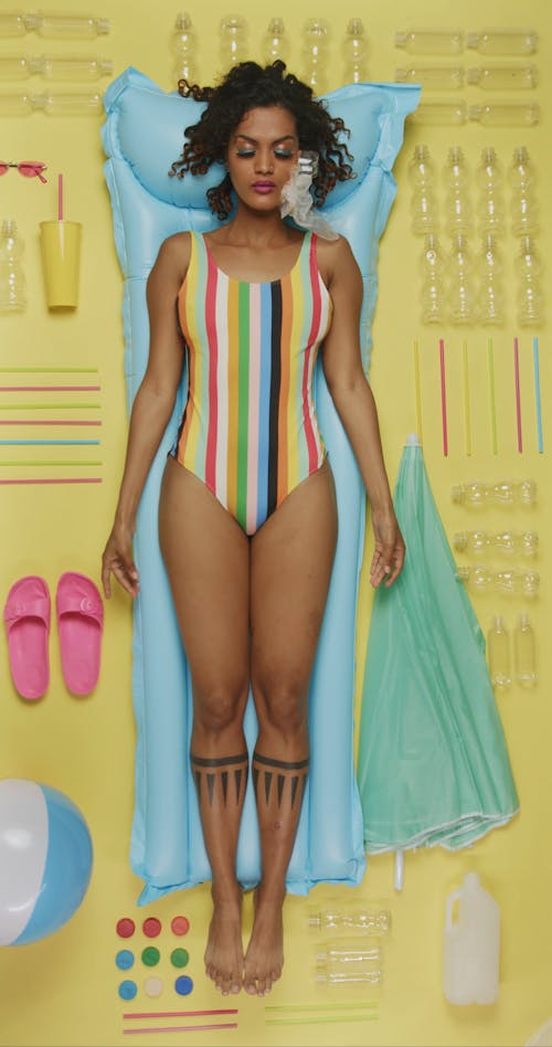 A Woman Lying on a Pool Float while Wearing a Colorful Swimsuit