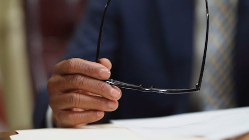 Person Holding an Eyeglasses