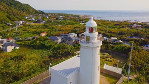 White Lighthouse Over a Village