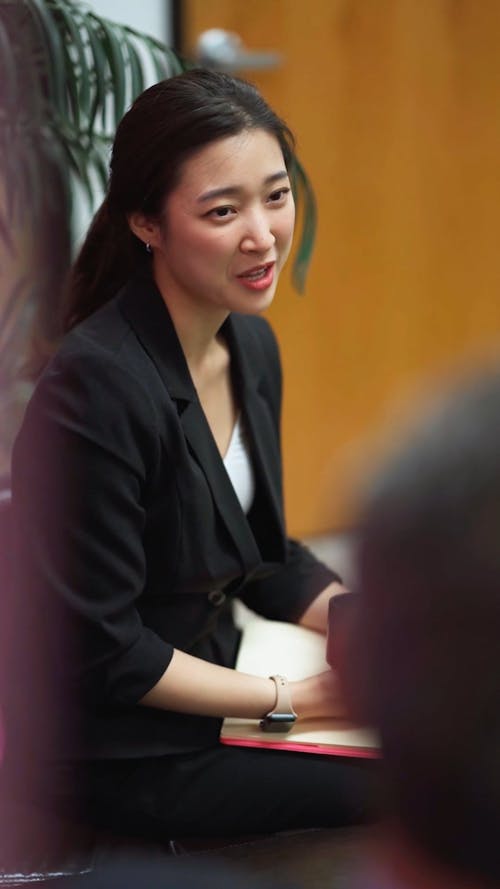 A Woman Talking to a Coworker in an Office