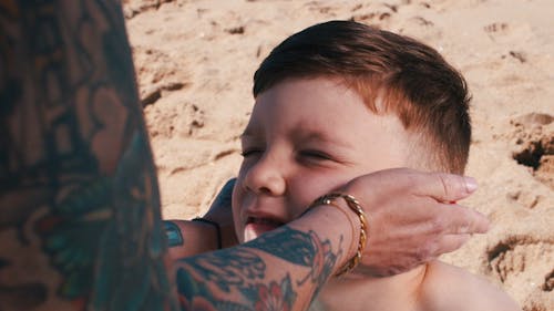 Parent Applying Sunscreen on Boy Face