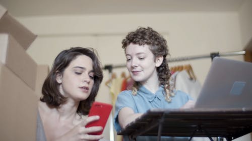 Women Looking at the Screen of a Cellphone