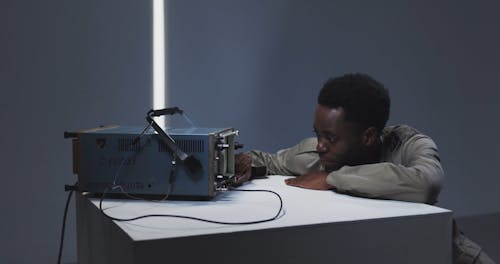 A Man Looking at an Electrical Instrument