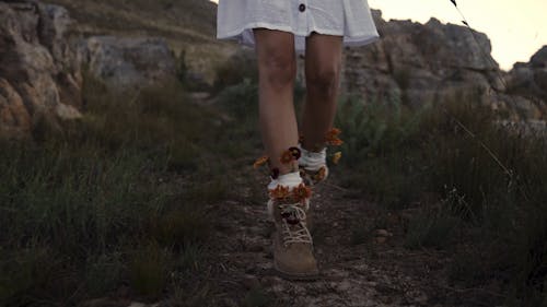 A Girl Walking with Flowers on Her Shoes