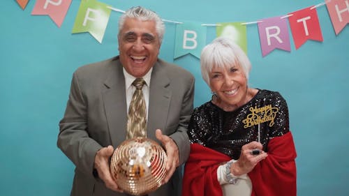 An Elderly Couple Enjoying at a Birthday Party