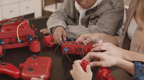 A Group of People Fixing a Machine